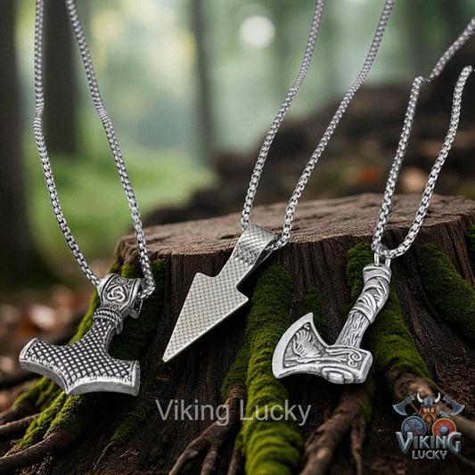 Three silver Viking-style pendants on chains resting on a mossy wooden surface with 'Viking Lucky' branding.