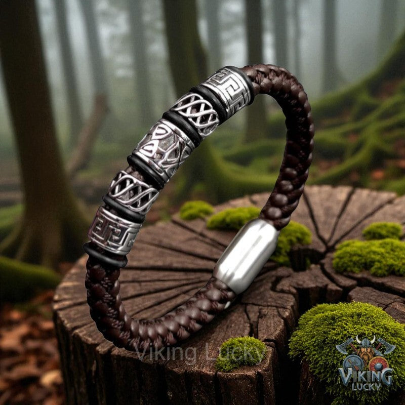 Brown braided bracelet with silver accents on a wooden stump in a forest setting, featuring 'Viking Lucky' branding.
