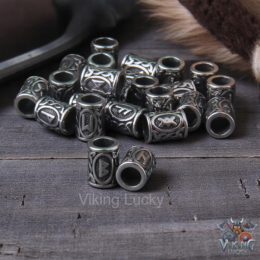 Silver beads with intricate designs on a wooden surface, branded 'Viking Lucky'.