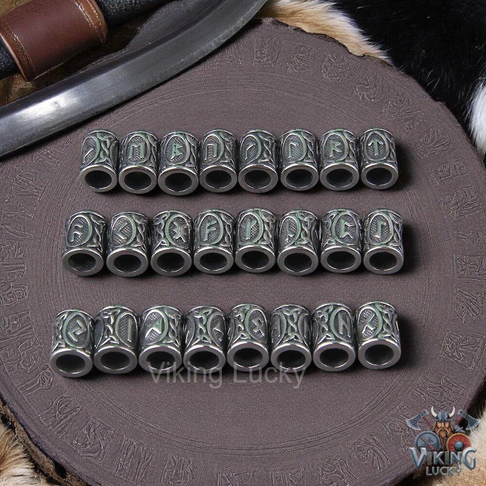 Set of silver beads with runic designs on a decorative surface with 'Viking Lucky' branding.