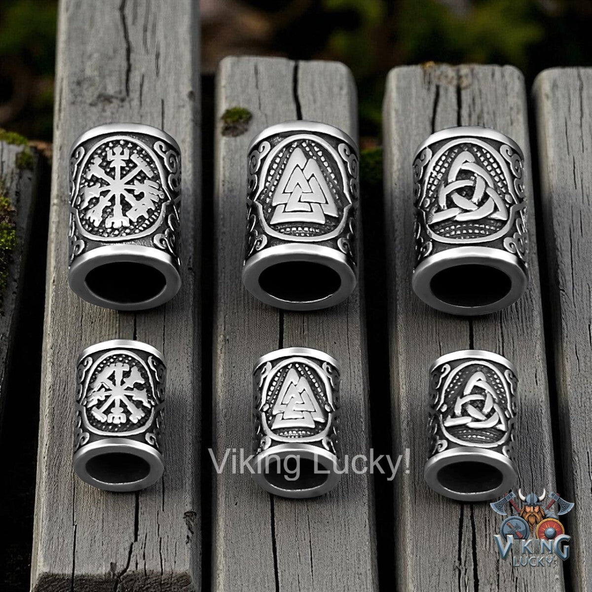 Set of silver Viking-themed rings on wooden planks with 'Viking Lucky!' branding.