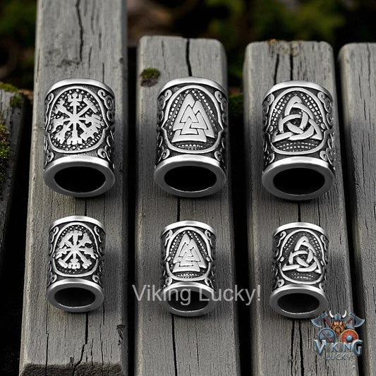 Set of silver Viking-themed rings on wooden planks with 'Viking Lucky!' branding.