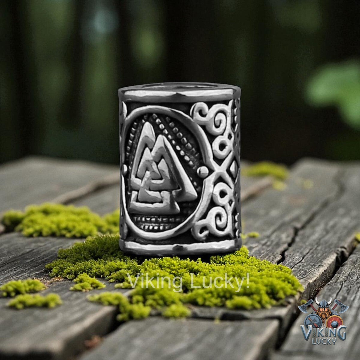 Silver Viking Lucky amulet on a wooden surface with green moss