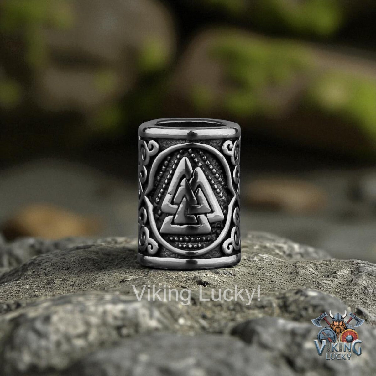 Silver Viking Lucky ring with a triangle design on a stone surface