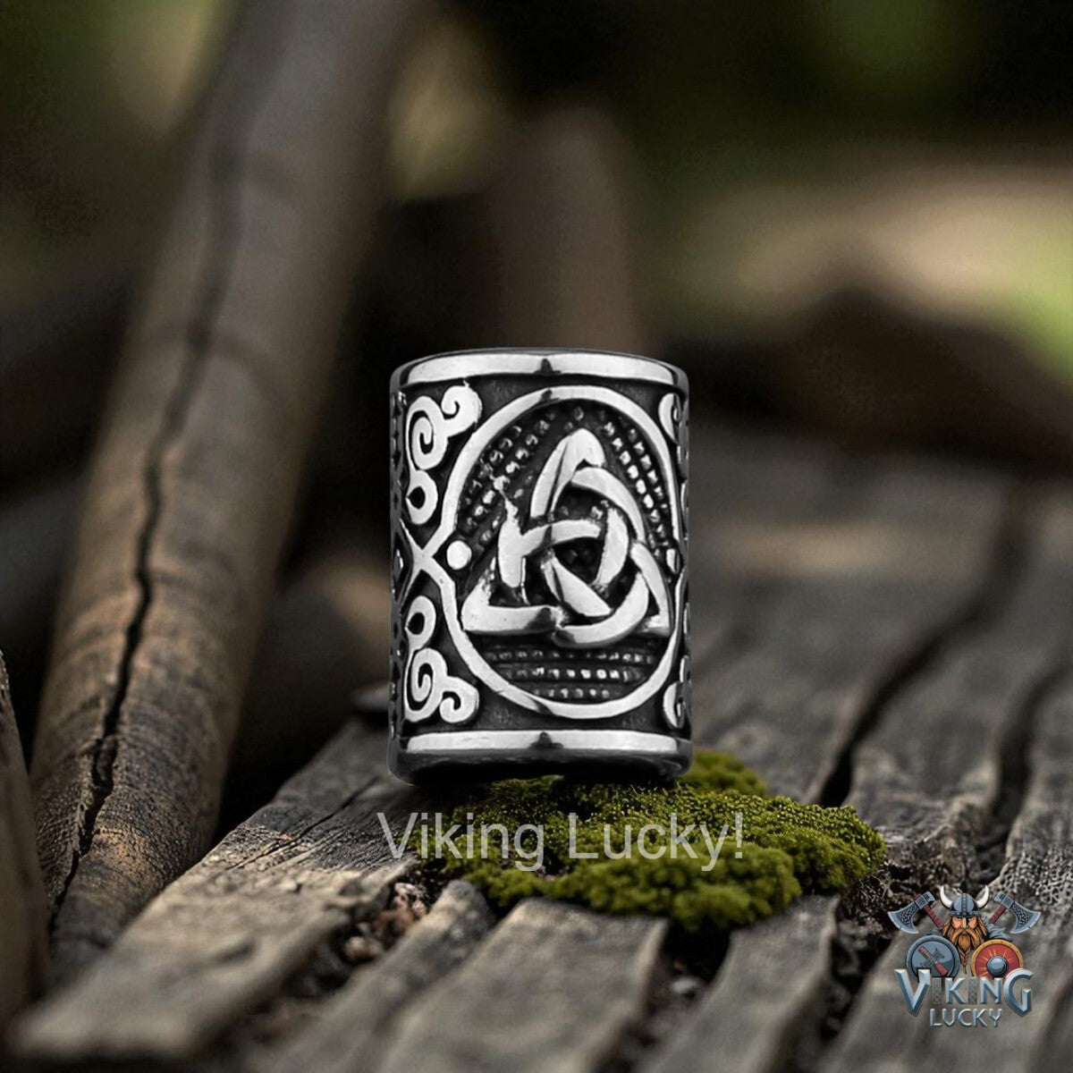 Decorative ring with intricate designs on a wooden surface, featuring the brand 'Viking Lucky'.