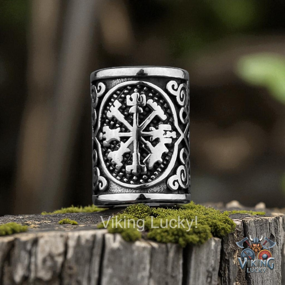 Silver Viking Lucky amulet on a wooden stump with a blurred natural background