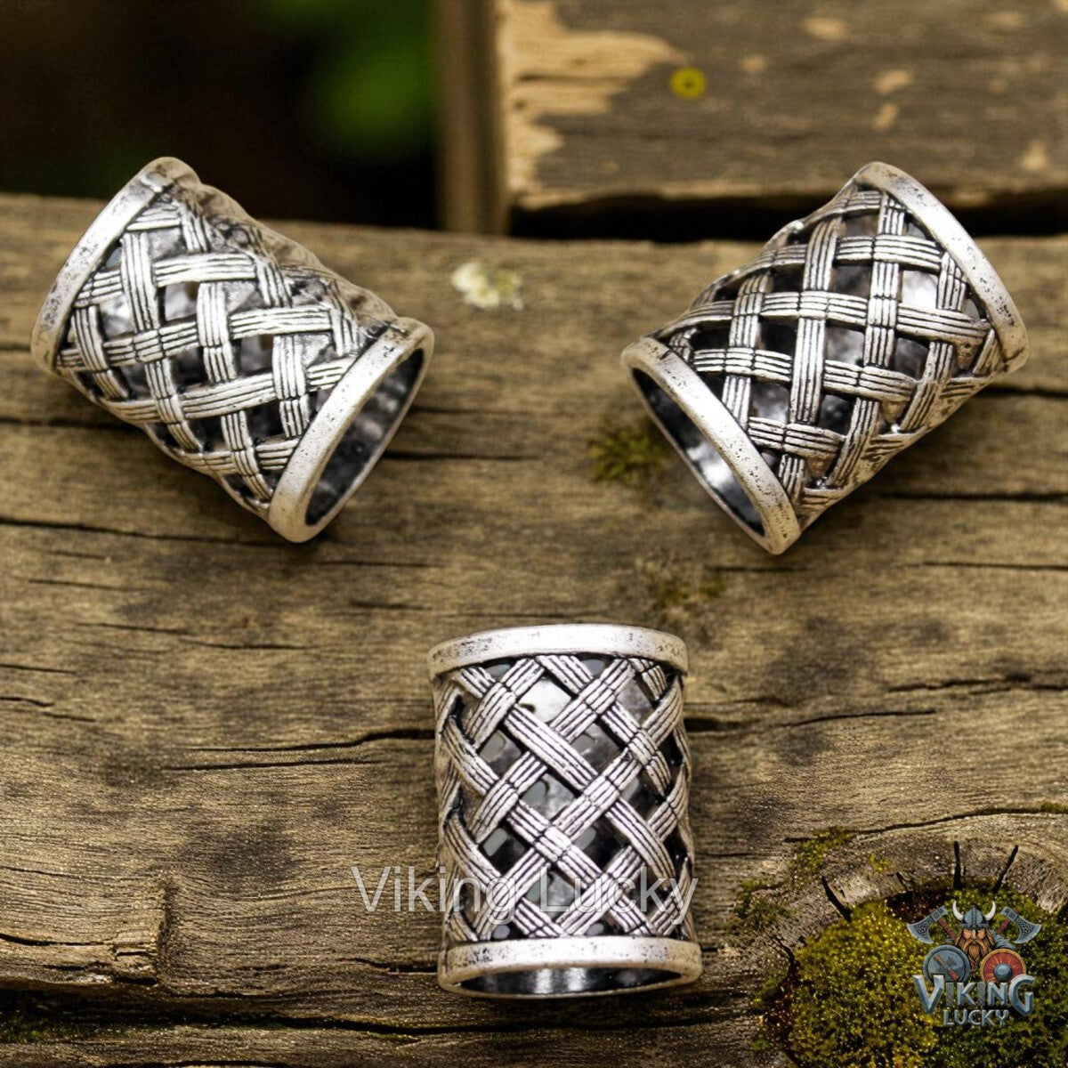 Three silver thimbles with woven design on a wooden surface, branded 'Viking Lucky'.