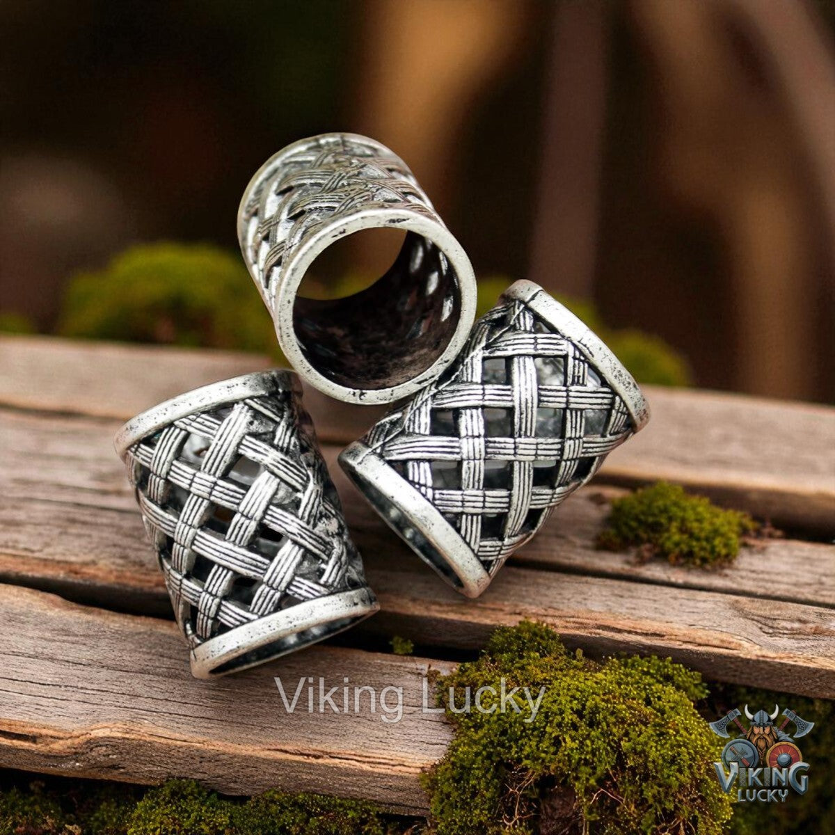 Three silver rings with intricate patterns on a wooden surface, branded 'Viking Lucky'.