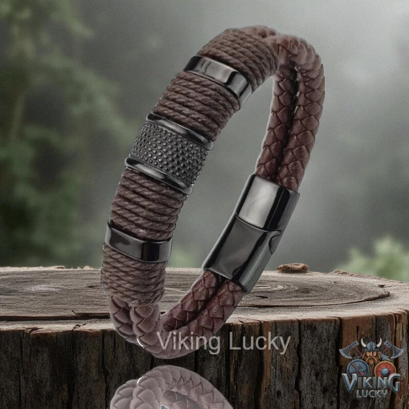 Brown braided bracelet with metal accents on a wooden surface, featuring 'Viking Lucky' branding.