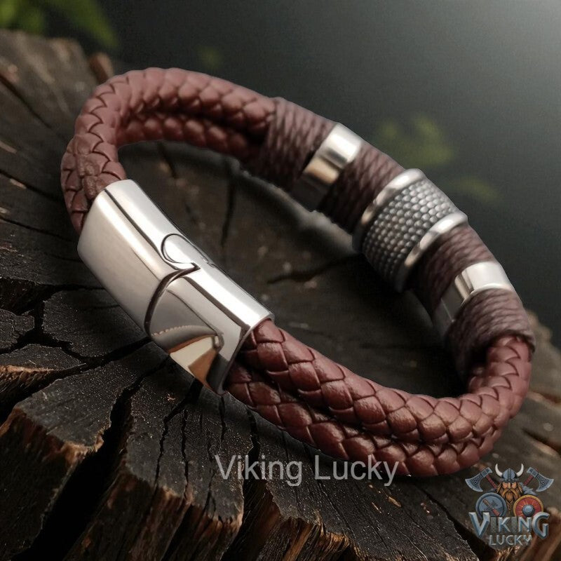 Brown braided leather bracelet with silver clasp on a wooden surface, featuring 'Viking Lucky' branding.