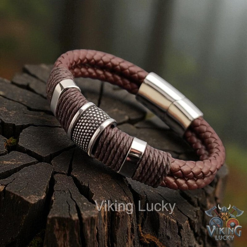 Brown braided leather bracelet with silver accents on a wooden surface, featuring 'Viking Lucky' branding.