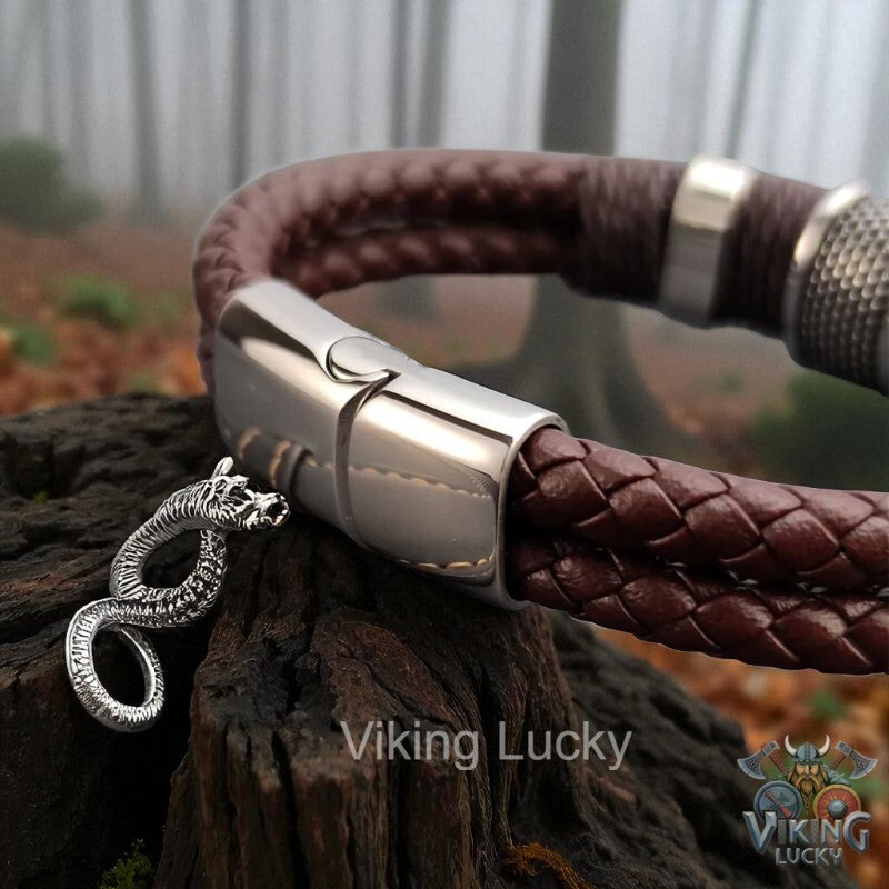 Brown braided leather bracelet with silver clasp on a wooden surface, featuring 'Viking Lucky' branding.