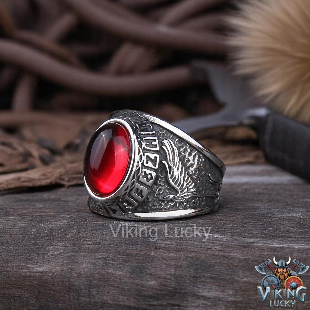 Viking Red Rune Wolf Ring with Norse carvings and red-eyed wolf head close up photo
