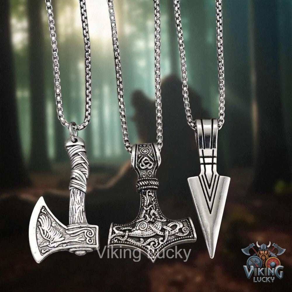 Three silver Viking-style pendants on chains against a blurred forest background, with 'Viking Lucky' branding.