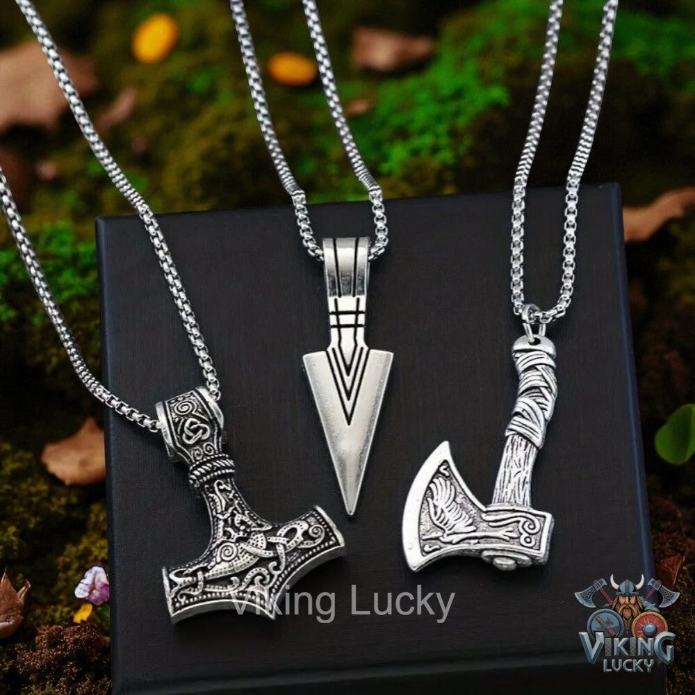 Three silver Viking-style pendants on black display card with 'Viking Lucky' branding.